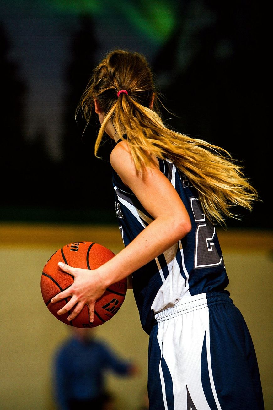 Girl holding a basketball 